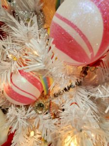 Pink and white christmas ball ornaments on white tree