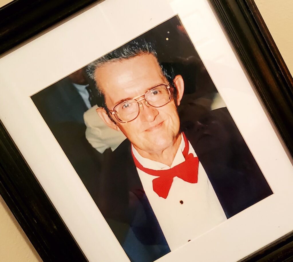 Frame photo of a man in a red bowtie and dark jacket