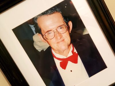 Frame photo of a man in a red bowtie and dark jacket