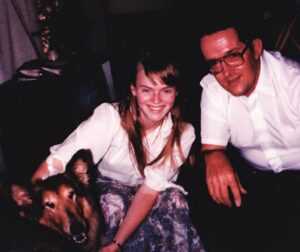 Daughter and father with collie smiling